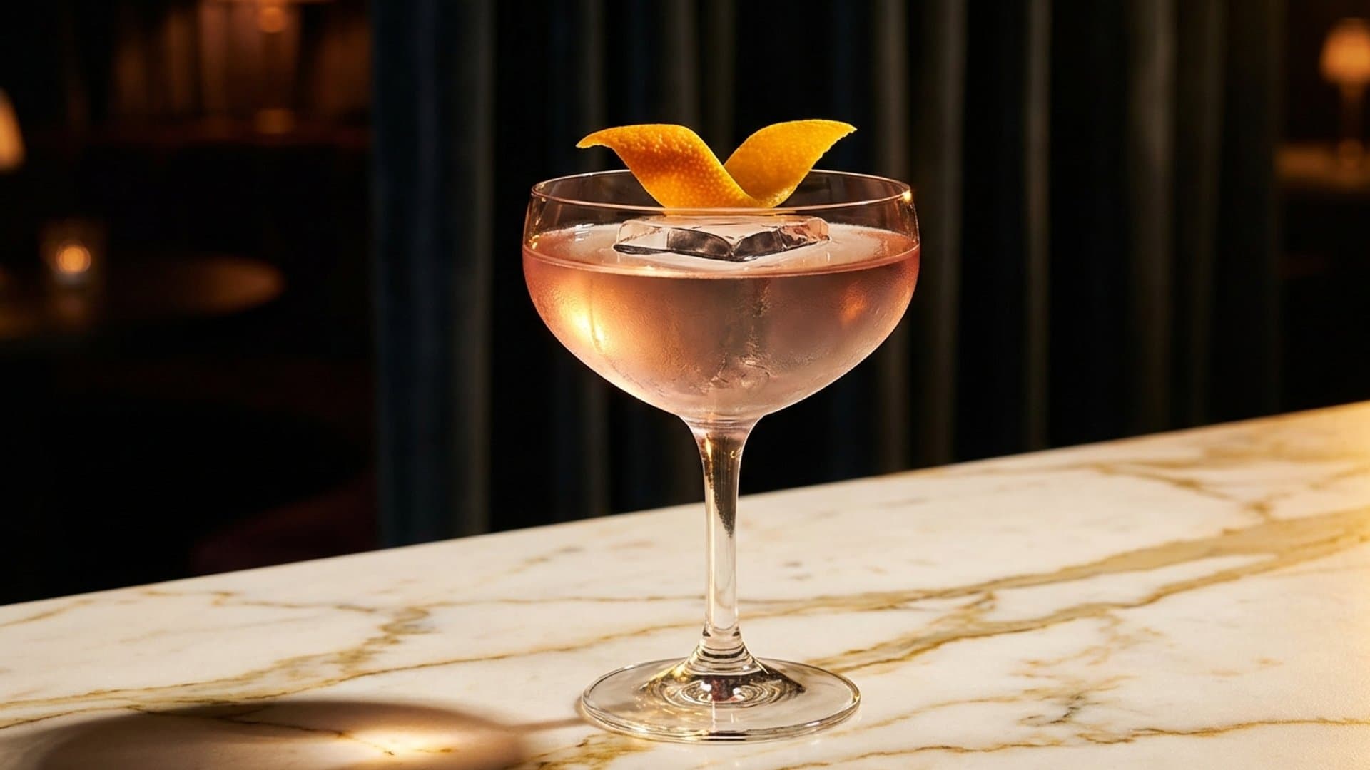 Golden Nocturne cocktail in a coupe or rocks glass garnished with expressed orange peel