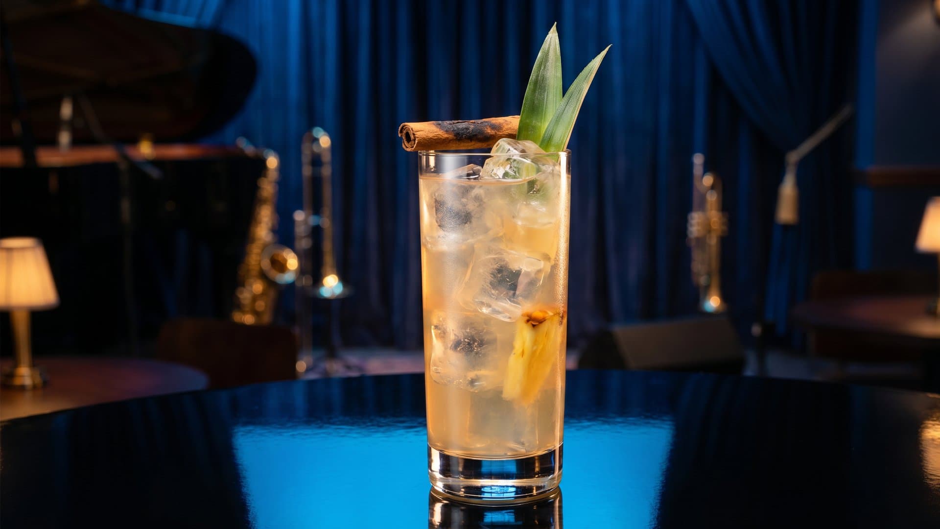 Tepache Fantasma cocktail in a Collins glass garnished with Torched cinnamon stick and pineapple frond