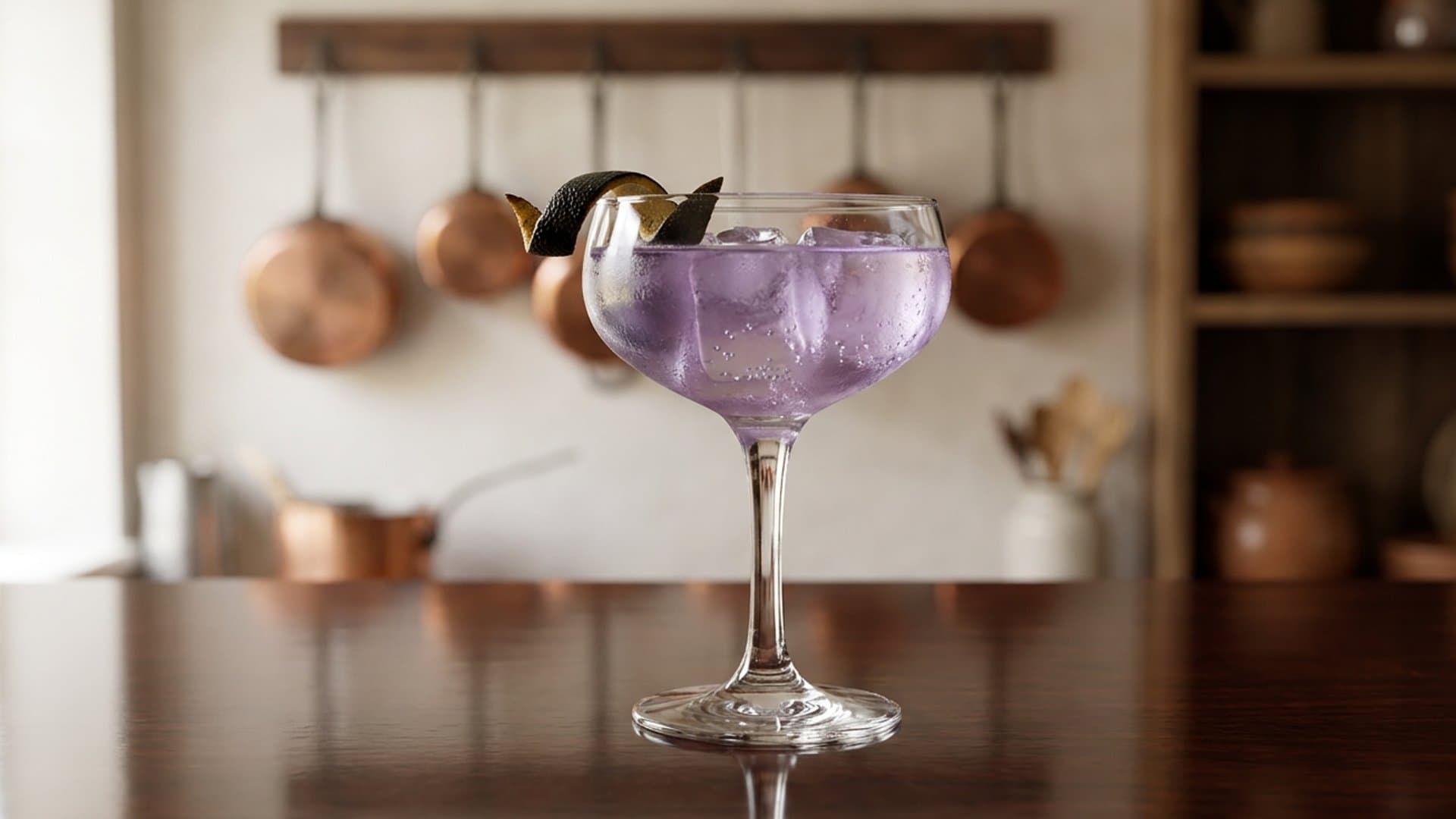 The Wednesday cocktail in a coupe garnished with charred lemon peel
