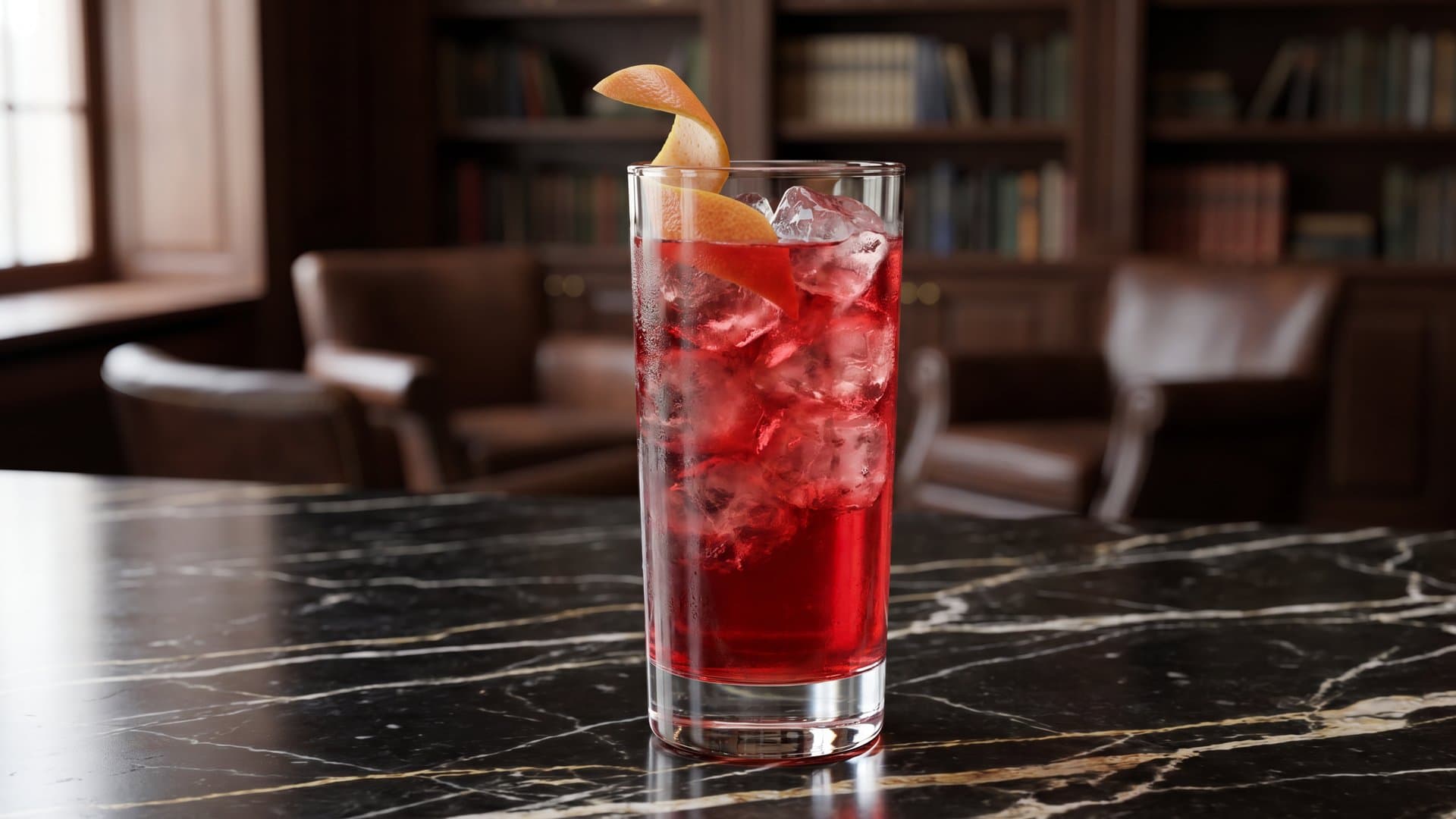 Crimson Horizon cocktail in a highball garnished with grapefruit peel