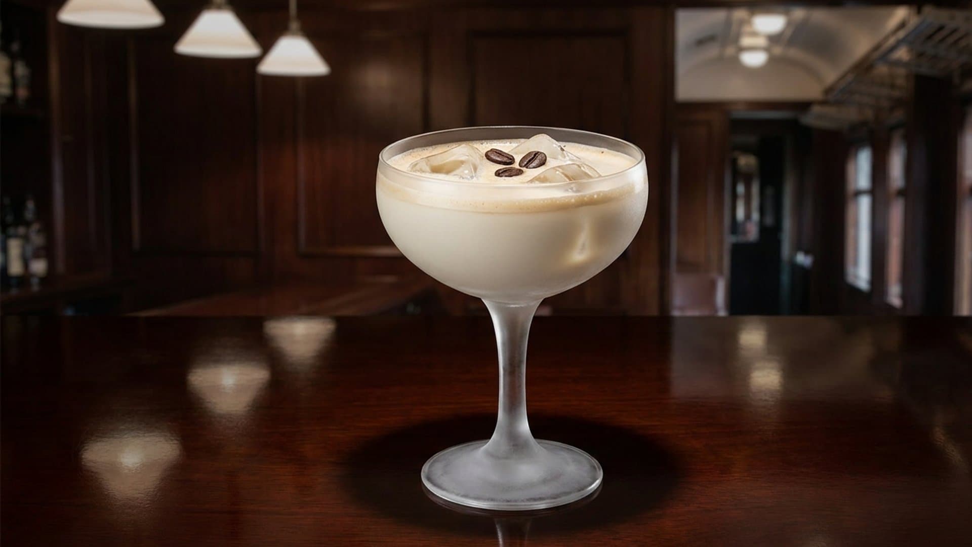 Hazelnut Affogato Martini cocktail in a coupe garnished with 3 espresso beans floated on foam
