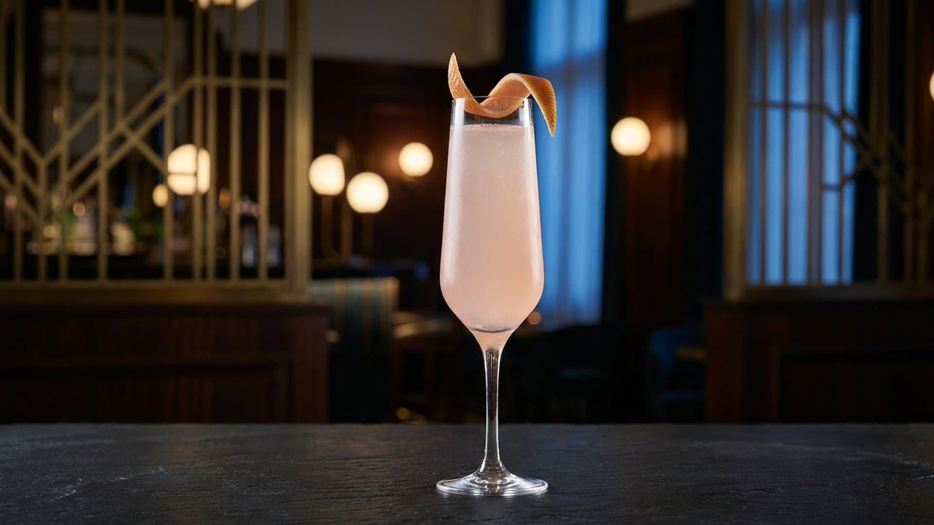 Toast of the Morning cocktail in a champagne flute garnished with grapefruit peel twist