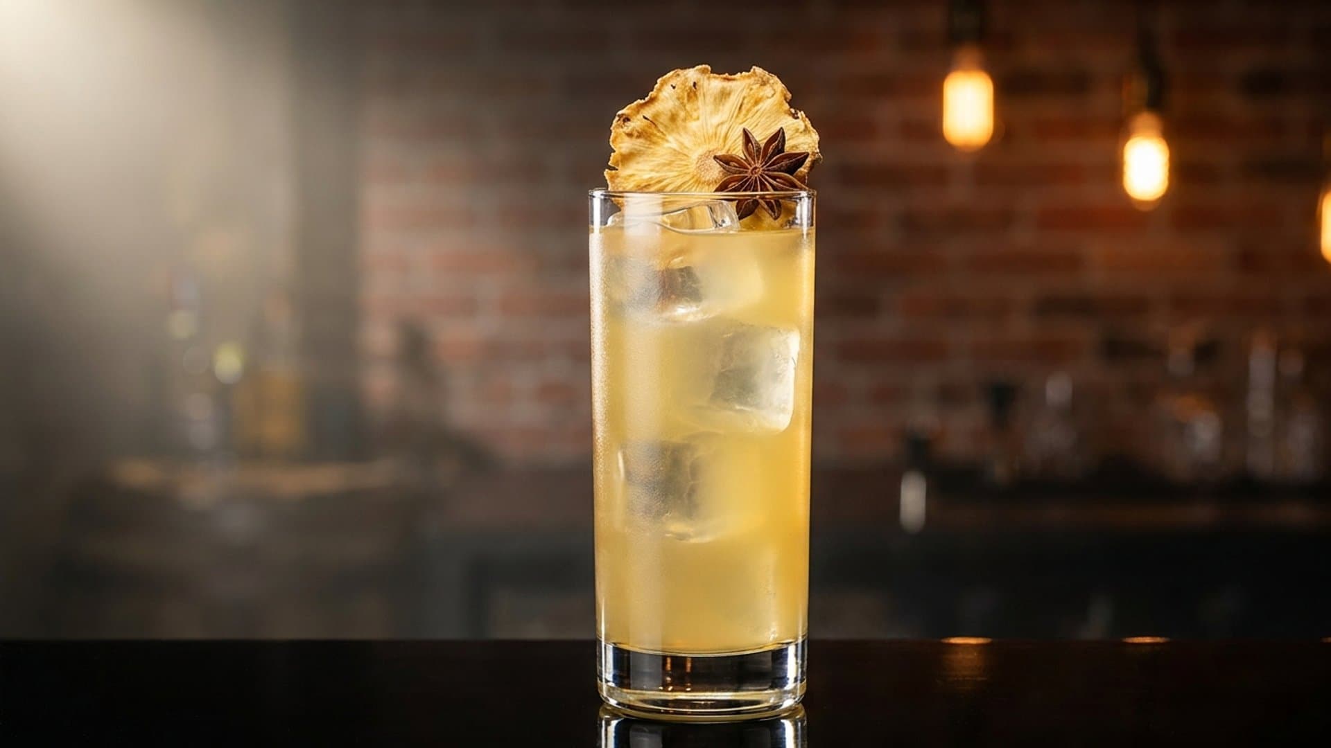 Tepache Fantasma cocktail in a Collins garnished with Dried pineapple chip and star anise pod