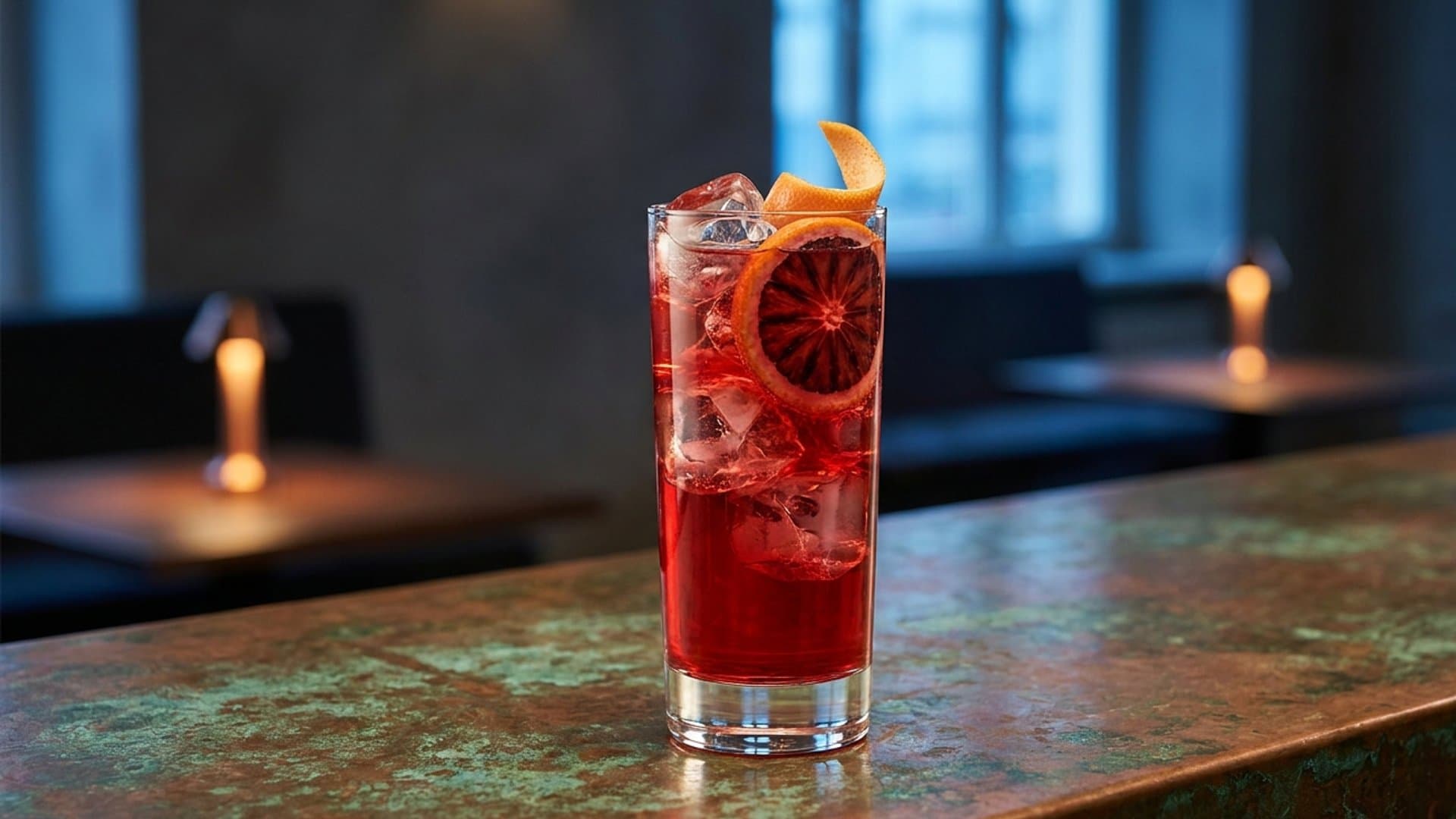 Sunset Boulevard cocktail in a highball garnished with Blood orange wheel with expressed grapefruit peel