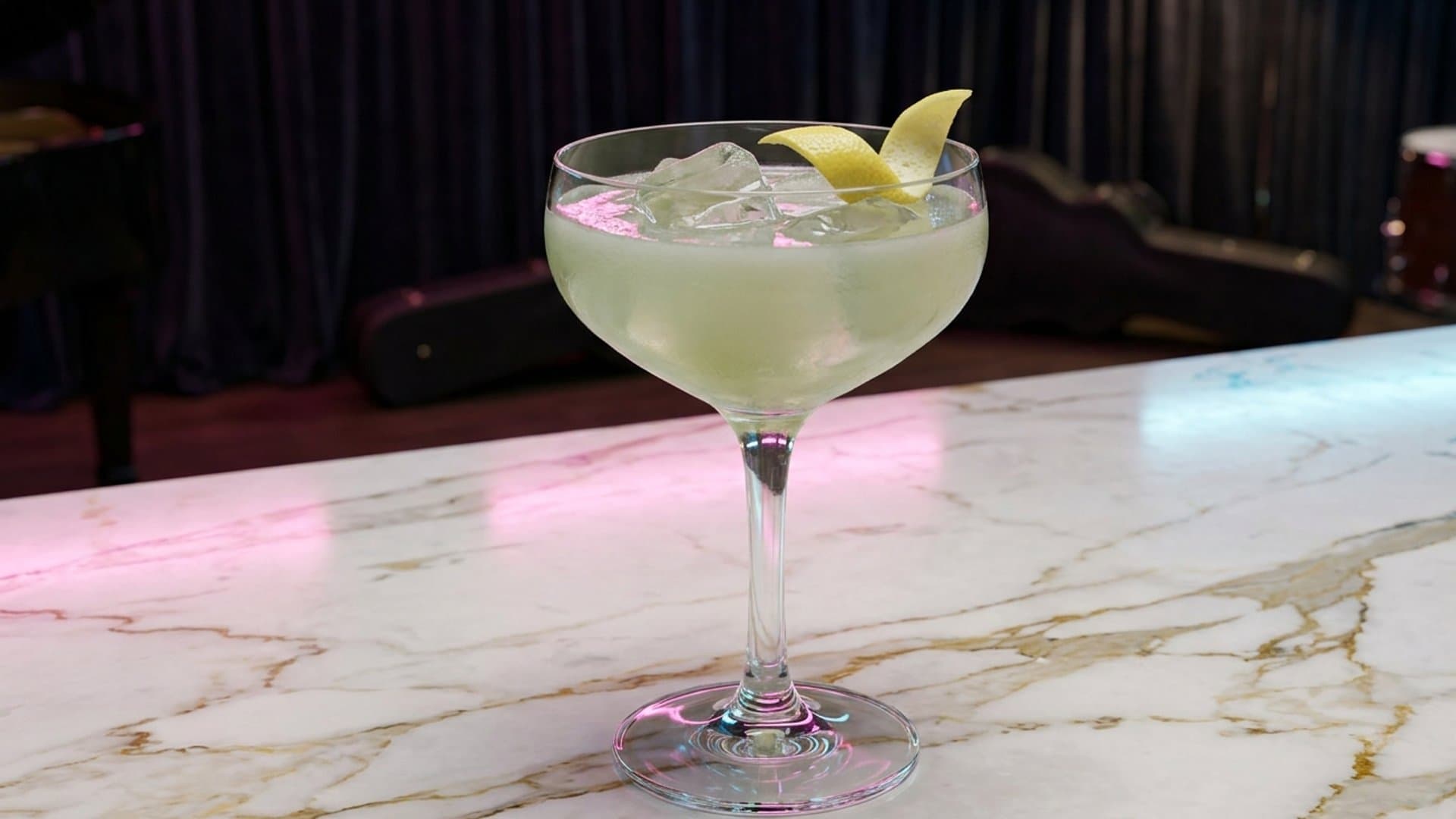 The Gilded Age cocktail in a coupe garnished with lemon peel twist