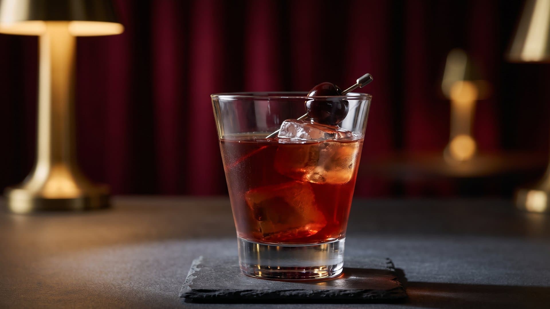 The Monastery Manhattan cocktail in a coupe or nick & nora garnished with brandied cherry