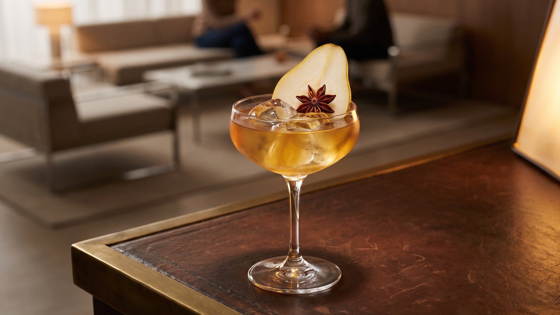 Orchard Breeze Daiquiri cocktail in a coupe garnished with Thin pear slice and star anise pod