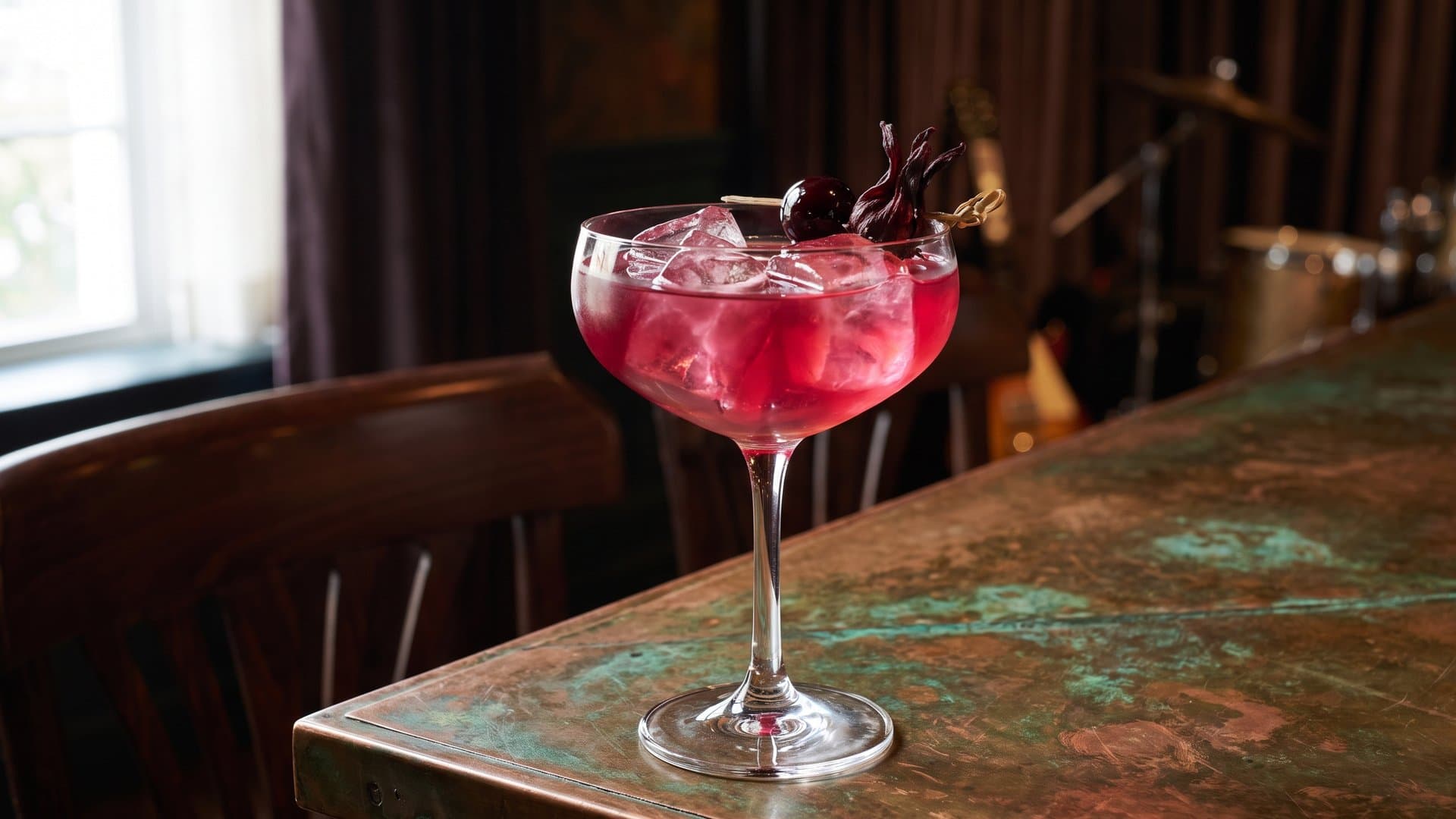 Spice Trade Manhattan cocktail in a coupe garnished with brandied cherry
